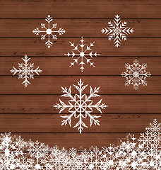 Image showing Set snowflakes on wooden texture