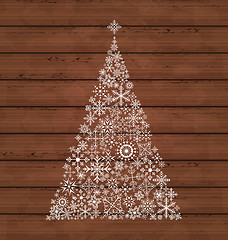 Image showing Christmas pine made of snowflakes on wooden background