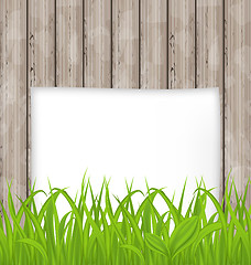 Image showing Green grass and paper sheet on wooden texture