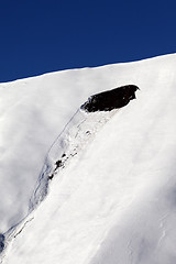 Image showing Trace of avalanche on off piste slope in sun day. Close-up view.