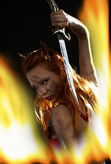 Image showing dark devil girl with a knife in fire