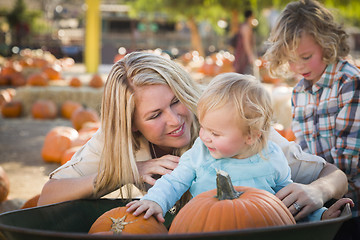 Image showing Young Family Enjoys a Day at the Pumpkin Patch