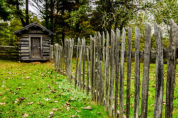 Image showing Beautiful Autumn scene showing rustic old log cabin surrounded b