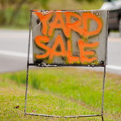 Image showing orange handwriting yard sale sign