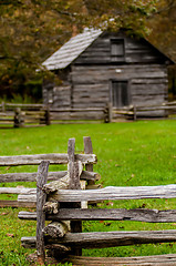 Image showing Beautiful Autumn scene showing rustic old log cabin surrounded b