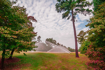 Image showing watering green grass lawn on golf course