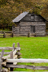 Image showing Beautiful Autumn scene showing rustic old log cabin surrounded b