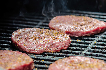 Image showing   tasty beef burgers on the grill