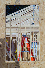 Image showing wood frame construction job seen trhough window opening