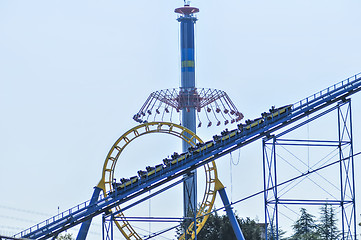 Image showing rollercoasters at an amusement park with blue sky