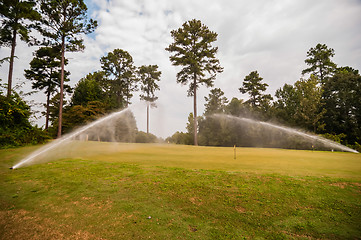 Image showing watering green grass lawn on golf course