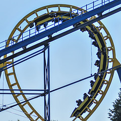 Image showing rollercoasters at an amusement park with blue sky