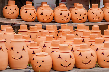 Image showing clay pumpkins standing happy near the wood fence