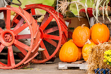 Image showing pumpkins next to an old farm tractor