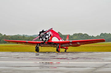 Image showing  red aerobatics plane parked due to rain