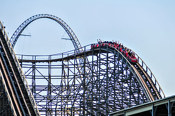 Image showing rollercoasters at an amusement park with blue sky