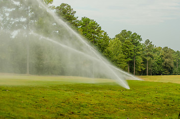 Image showing watering green grass lawn on golf course