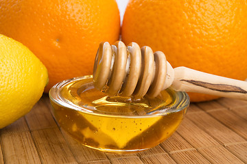 Image showing fresh honey with lemon and orange fruits