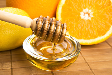 Image showing fresh honey with lemon and orange fruits