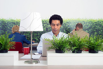 Image showing Business man at hot desk