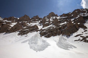 Image showing Snowy rocks and trace from avalanche