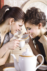 Image showing Happy girl-friends with cups