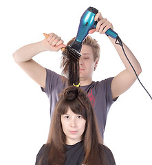 Image showing Woman enjoying having her hair blow dried