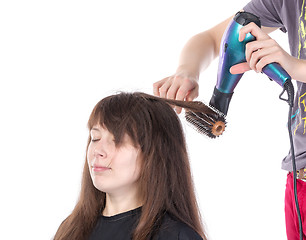 Image showing Woman enjoying having her hair blow dried