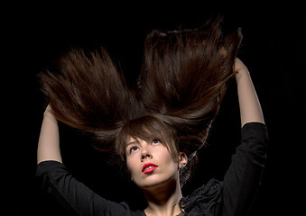 Image showing Young woman with her hair flying in the air