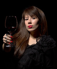 Image showing Young woman with red wine from a glass