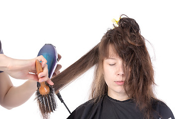 Image showing Woman enjoying having her hair blow dried