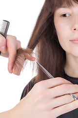 Image showing Young woman having a hair cut