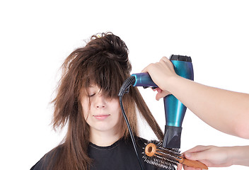 Image showing Woman enjoying having her hair blow dried