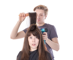 Image showing Woman enjoying having her hair blow dried