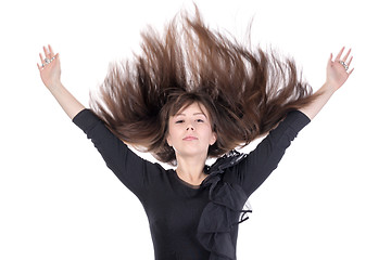 Image showing Young woman with her hair flying in the air