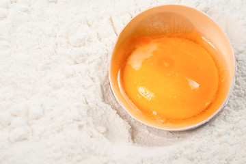 Image showing Egg yolk on flour