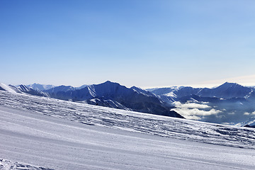 Image showing Ski slope and snowy mountain in haze