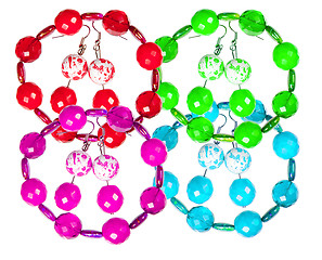 Image showing Earrings and bracelets made of plastic and glass on a white back