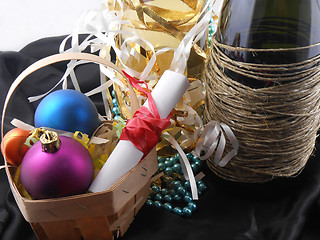 Image showing bottle of champagne, christmas balls and white invitation paper