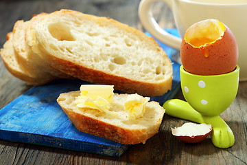 Image showing White bread with butter and egg in a stand.