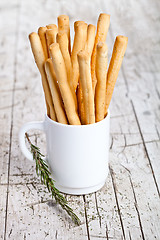 Image showing cup with bread sticks grissini and rosemary