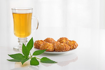 Image showing Tea, mint and cookies