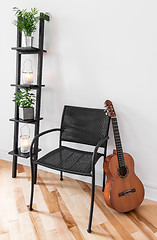 Image showing Room with simple furniture, plants and guitar