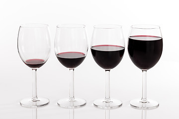 Image showing Glasses with different quantities of red wine