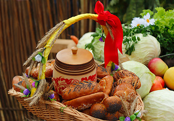Image showing Basket of bread, decorated with ribbons, and vegetables