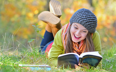 Image showing beautiful girl with book in autumn park