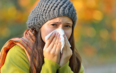 Image showing girl with allergy or cold using tissue