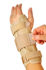 Image showing female wearing wrist brace over white background