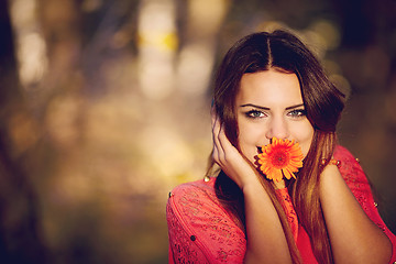 Image showing Girl with a flower in his mouth