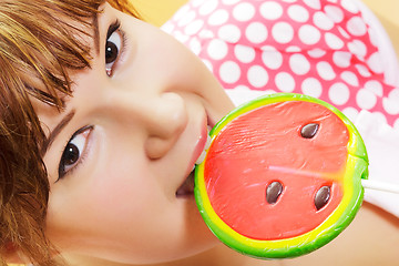 Image showing attractive girl with a round lollipop